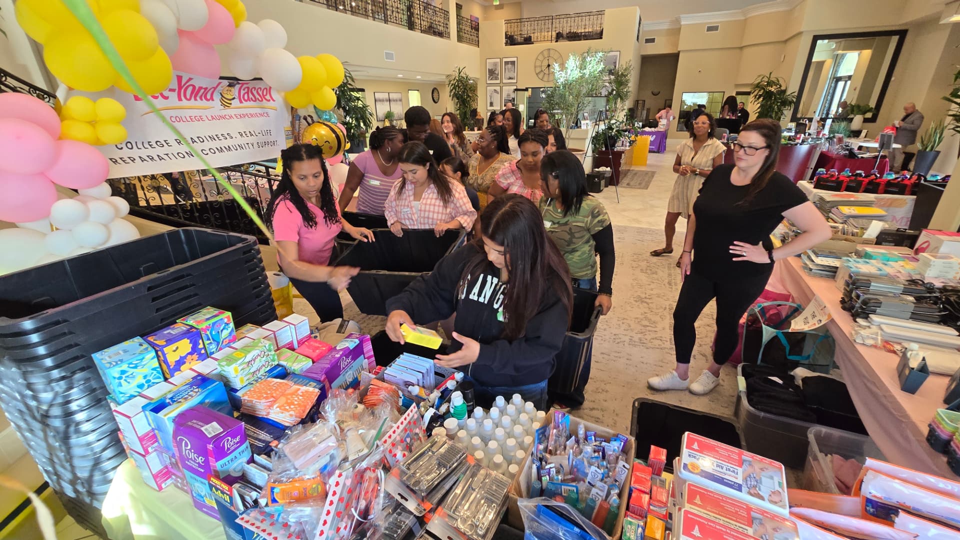 Volunteers prepare supplies at the Bee-yond the Tassel college launch event.